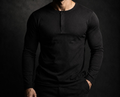 Man wearing the NORE Henley in black, fitted long-sleeve henley shirt, front view