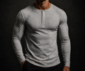 Man wearing the NORE Henley in heather gray, tapered long-sleeve henley, front view